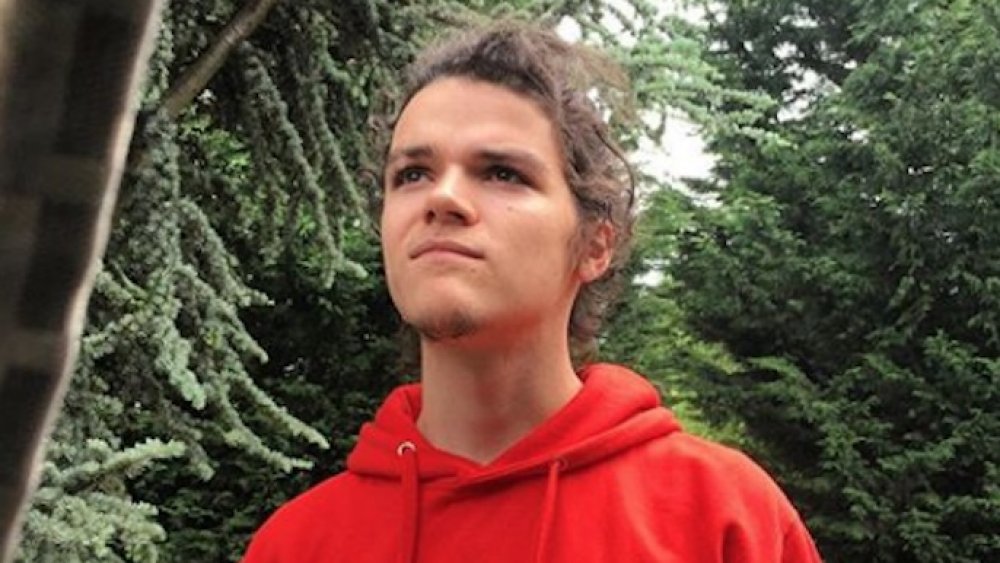 Little People, Big World's Jacob Roloff in the woods wearing a red hoodie