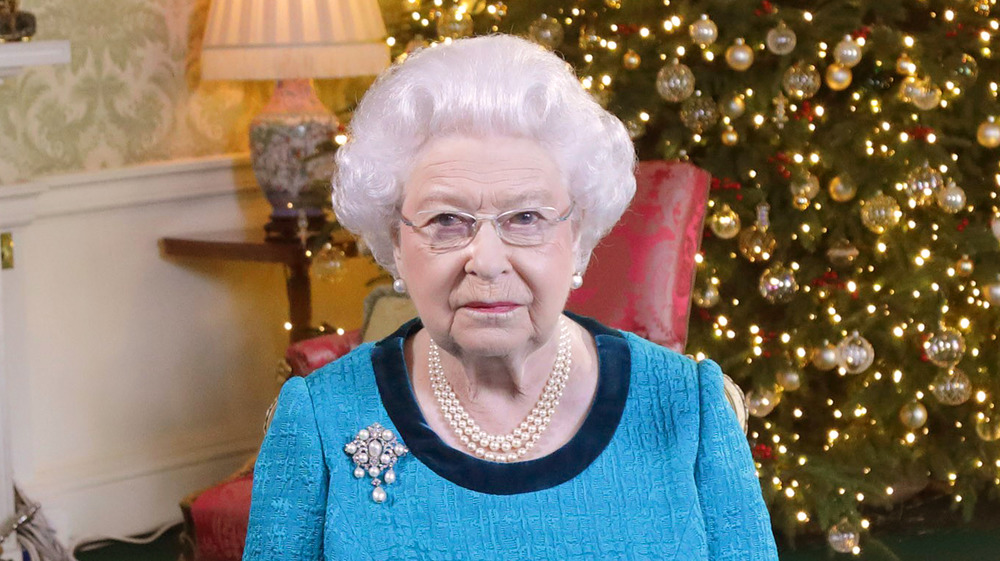 Queen Elizabeth in front of a Christmas tree