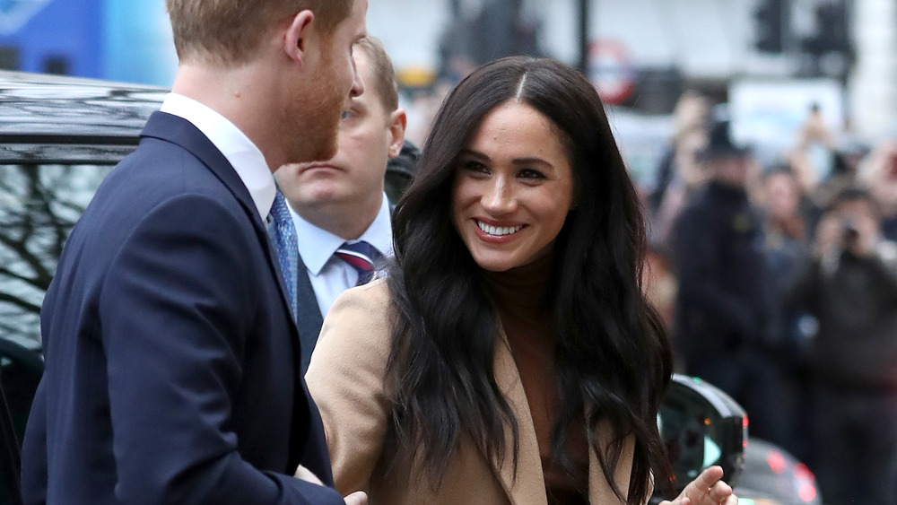 Meghan Markle and Prince Harry exiting a car