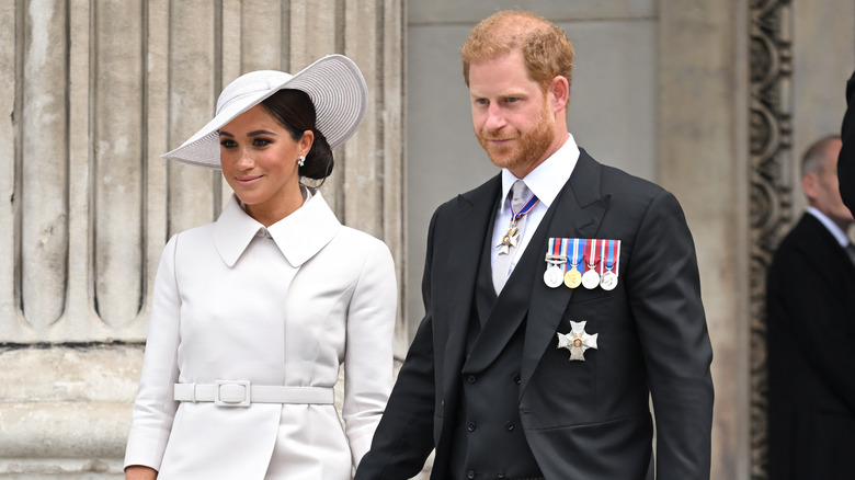 Meghan Markle wearing Dior and handling hands with Prince Harry in 2023