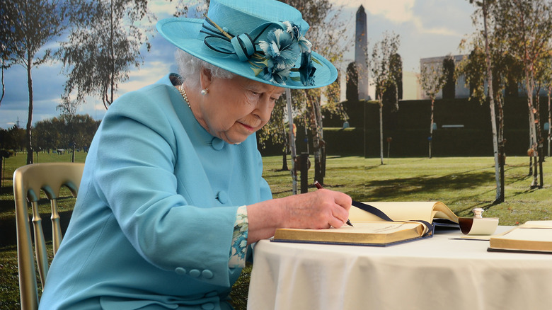 Queen Elizabeth writing in a book