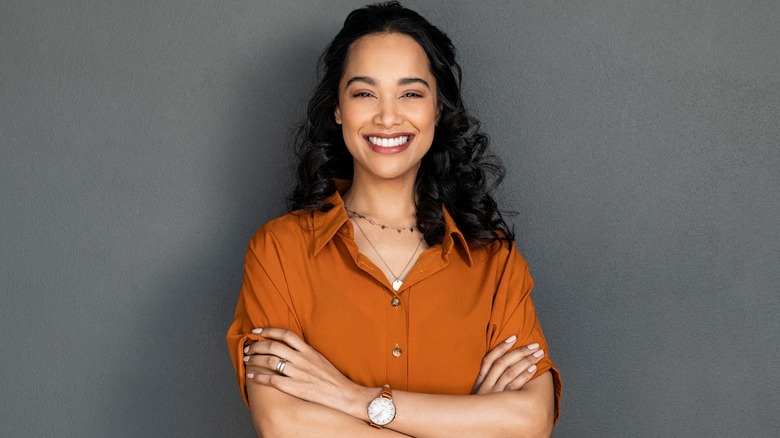 A woman smiles while posing for a photo. 