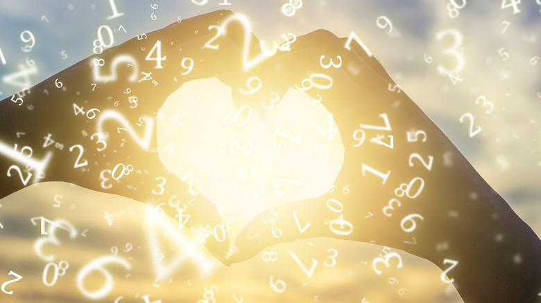 Woman making heart with hands surrounded by numbers 