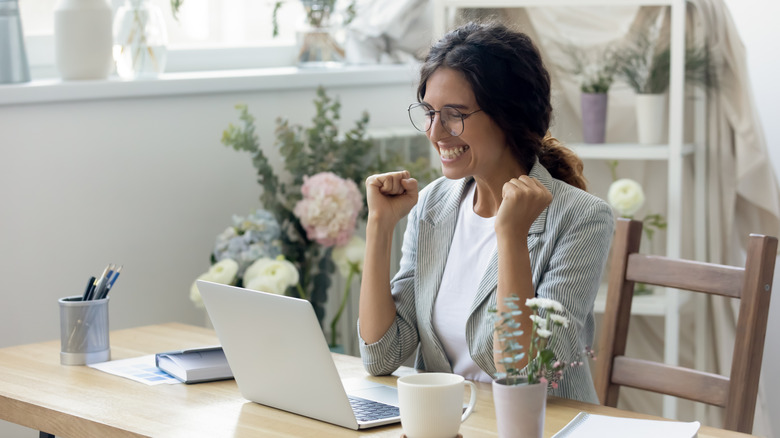 An excited woman with a computer