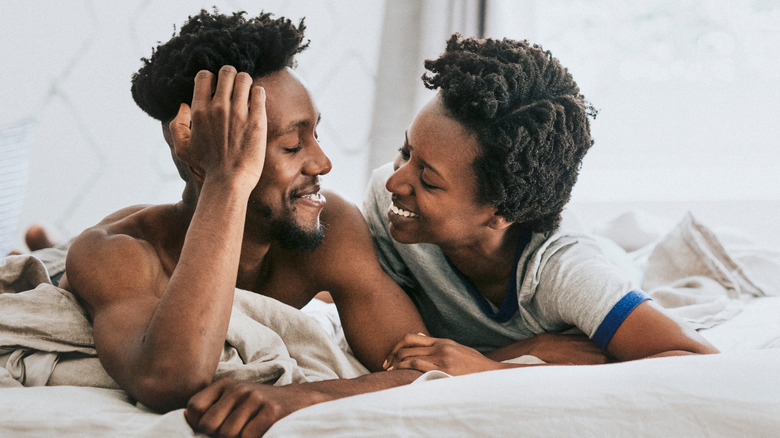 A happy couple relaxing in bed. 