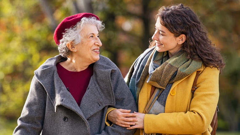 A woman walking with her grandmother. 