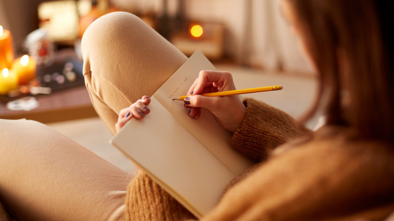 A woman writing in a journal