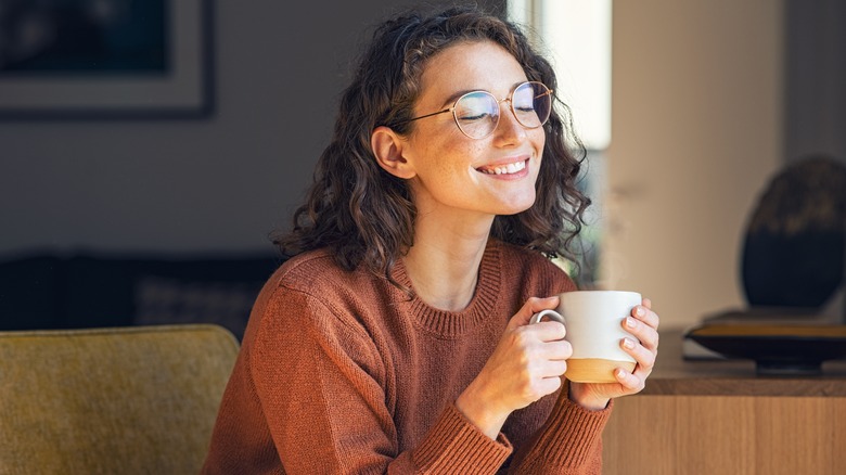 Woman relaxing with cup of coffee