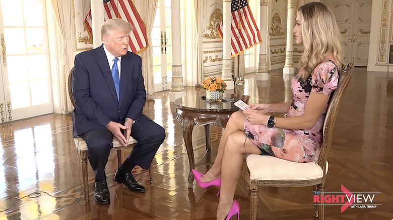 Donald Trump and Lara Trump sitting and talking