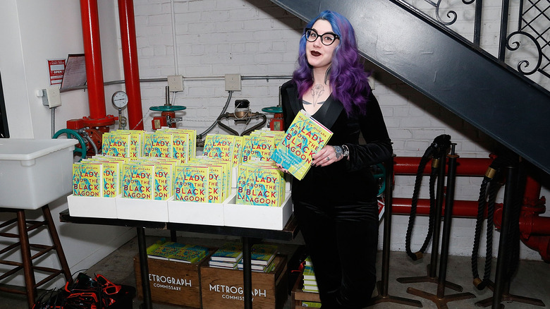 Author Mallory O'Meara posing with her book