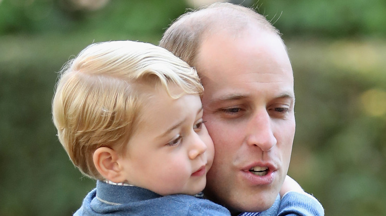 Prince William cuddles his son