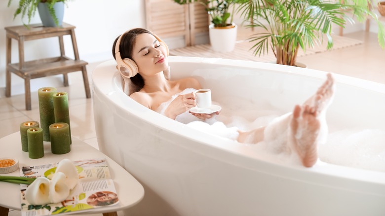 Woman relaxing in bathtub