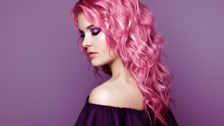 Young woman with wavy pink hair