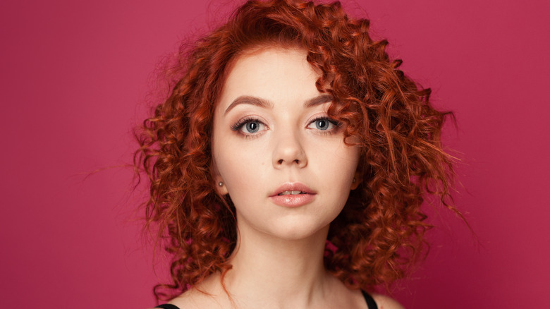 Young woman with red curly hair