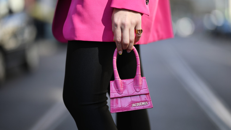 Woman carrying pink handbag