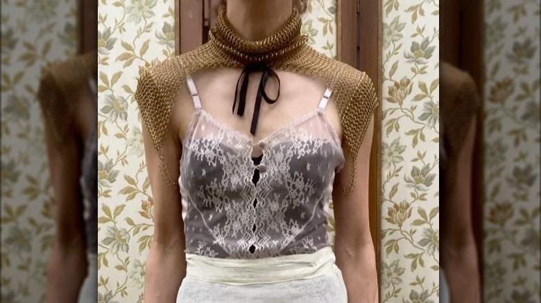 Woman in chain-linked sleeves