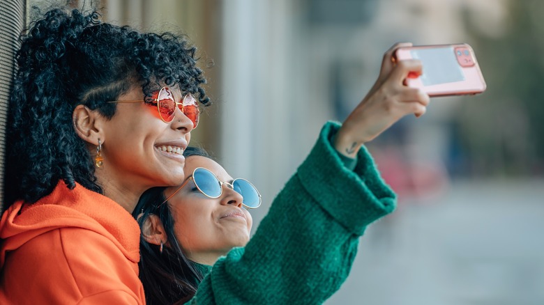 LGBTQIA+ couple taking selfie on date