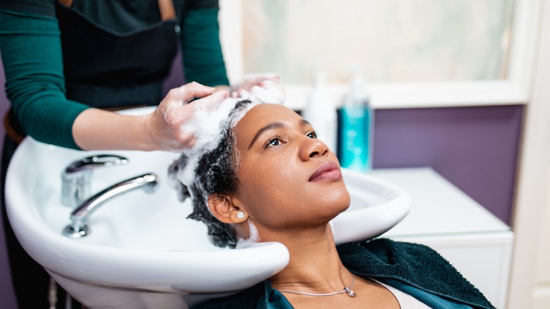 woman getting hair washed salon