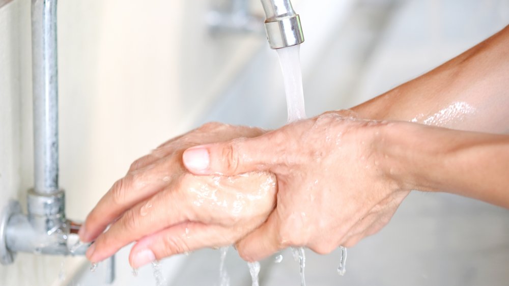 Washing your hands after handling an infected person's things