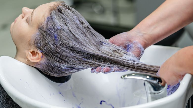 Girl having hair washed salon sink 