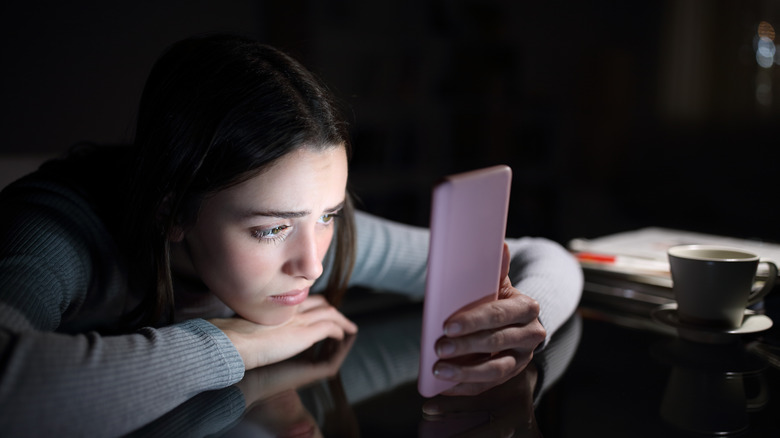 Woman is upset looking at phone