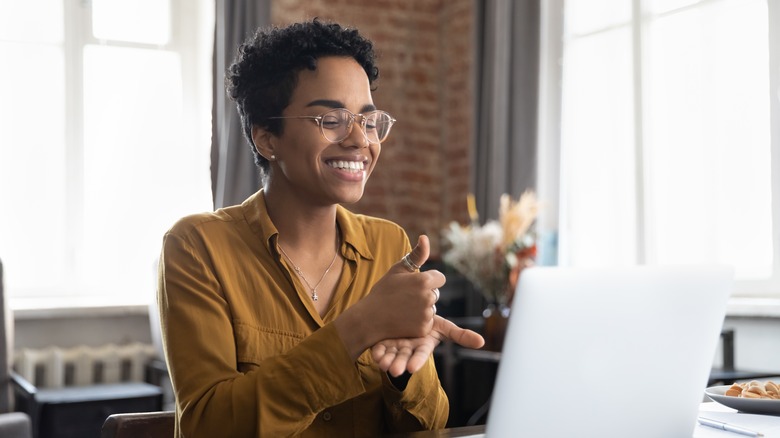 Person smiling with laptop