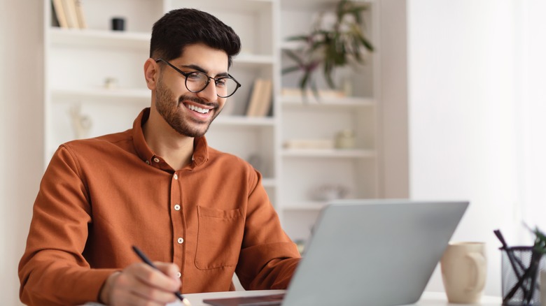 Man smiling on laptop