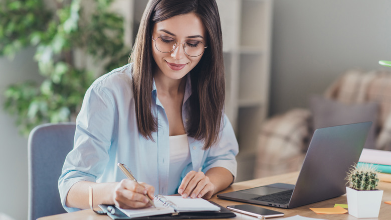 Woman writing in a notebook