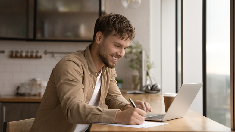 Man smiling on laptop