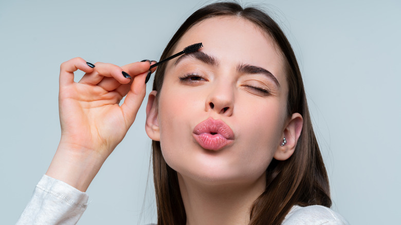 Woman using eyebrow brush