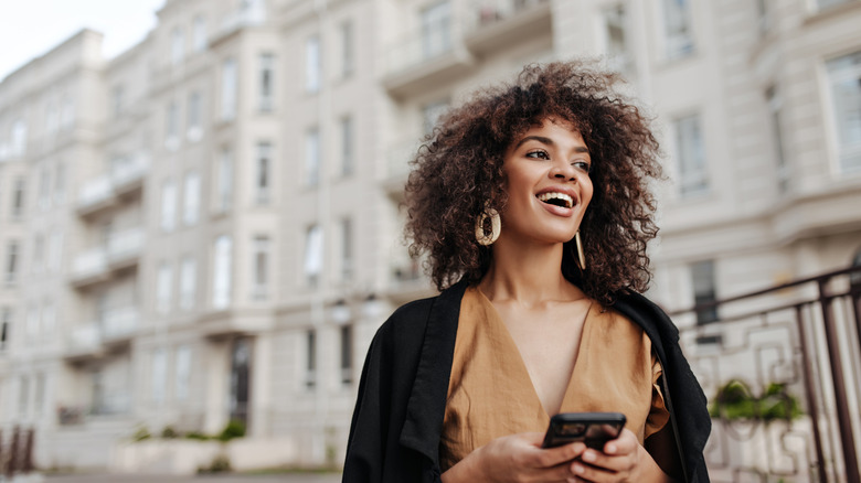 woman in city smiling 