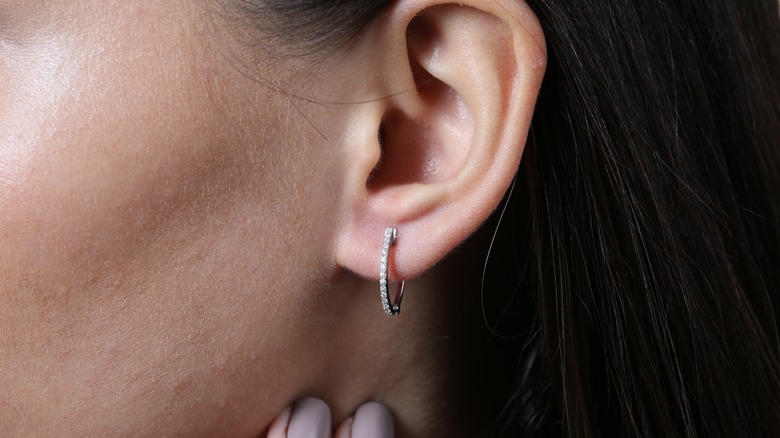 Earrings in woman's ear