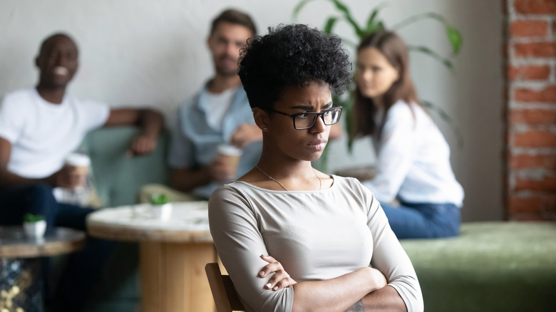 woman sitting outside of group