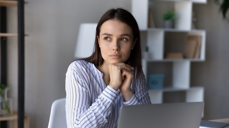 woman seated pensively 