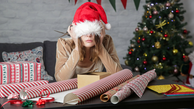 Woman sick of wrapping Christmas presents