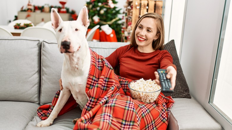 woman watching tv with dog