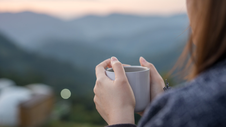 woman hold coffee outside