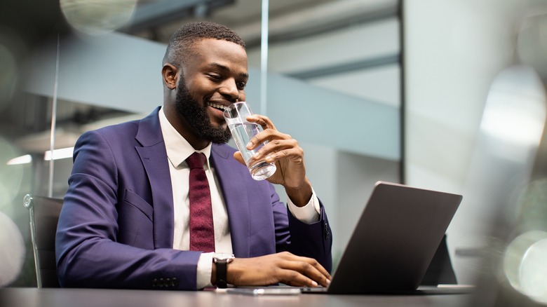 man in purple suit sends email