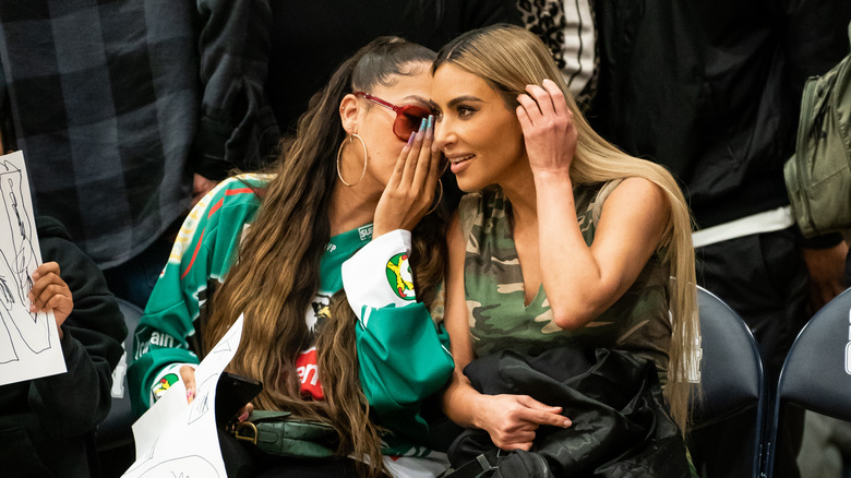 Kim Kardashian chats to Lala Anthony courtside at a basketball game