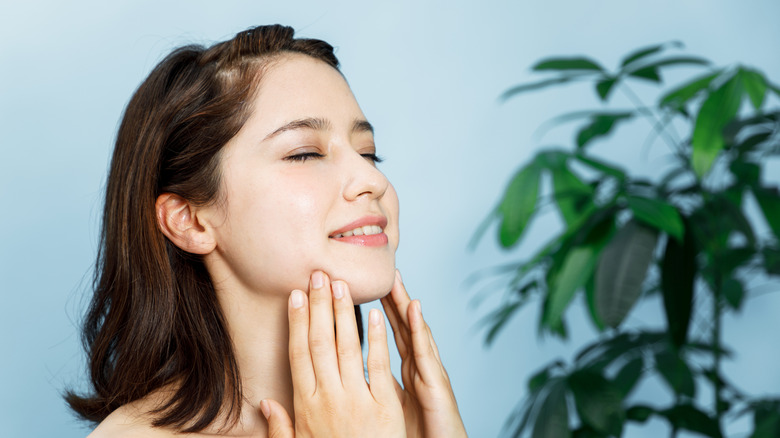 Woman performing lymphatic drainage massage