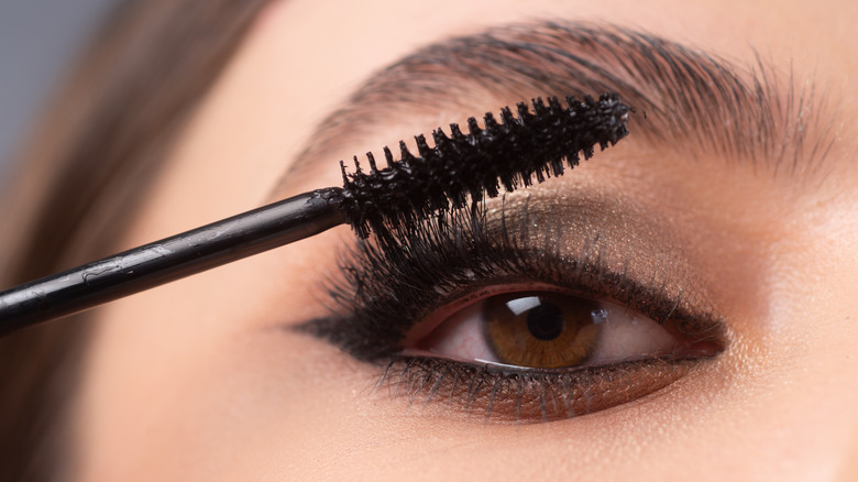 Woman applying mascara