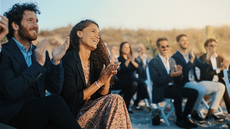 Wedding guests clapping and laughing 