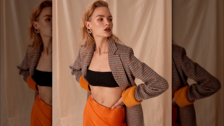 Woman poses in oversized blazer and bra combo