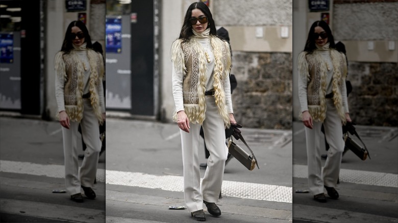 Woman in beige fur vest and sweater