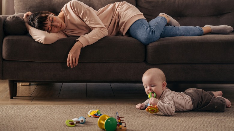 Mom sleeping, baby plays