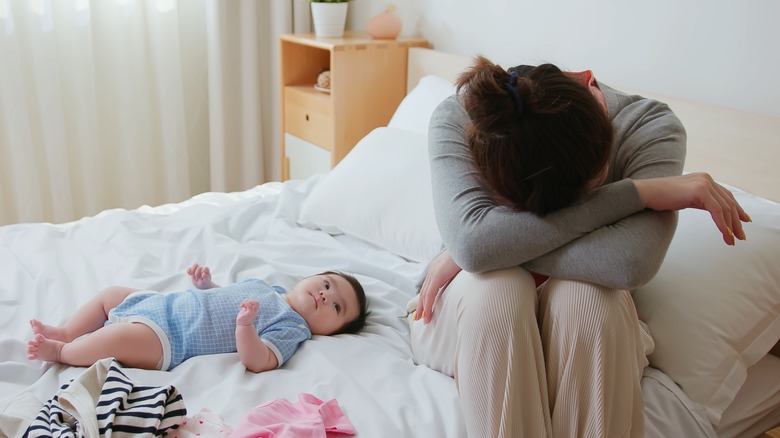 mom, baby on bed