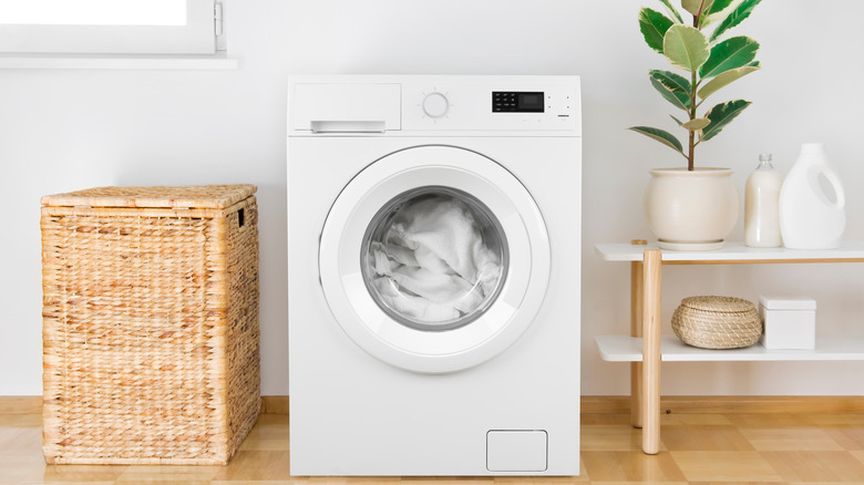 White washing machine in minimalist laundry room