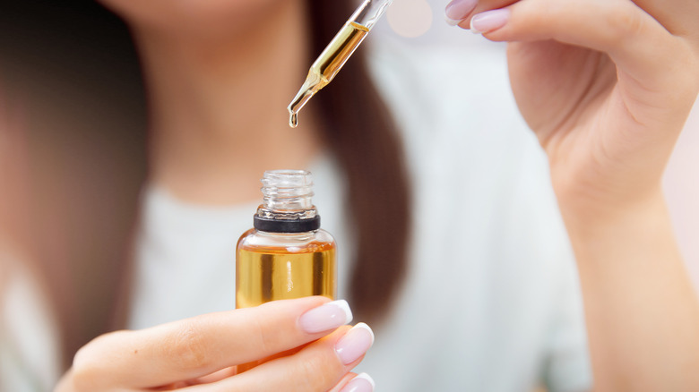 Woman holding oil cleanser