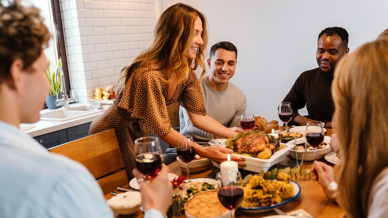 people smiling at table during Thanksgiving