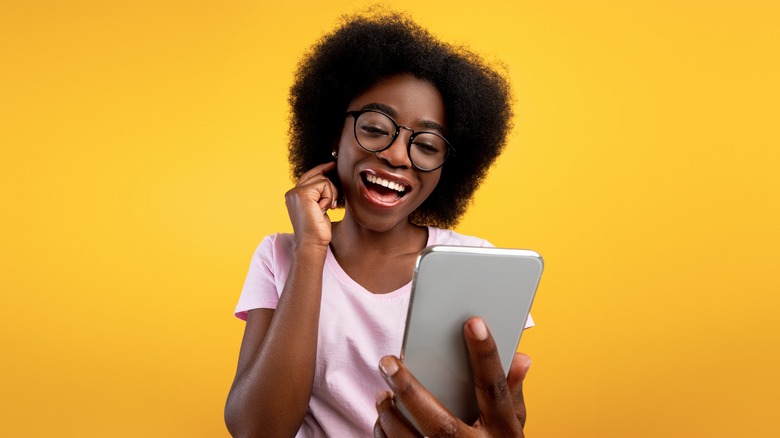 woman taking selfie bright yellow background